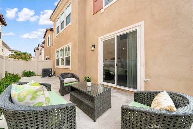 view of patio with central air condition unit, fence, and an outdoor hangout area