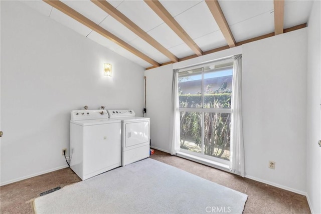 washroom featuring baseboards, carpet floors, laundry area, and washing machine and clothes dryer