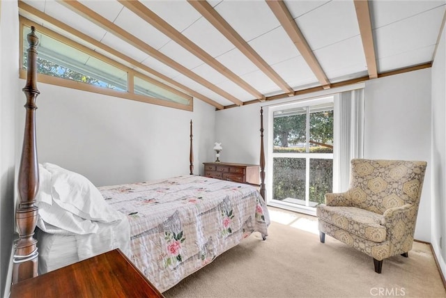 bedroom with lofted ceiling with beams and carpet flooring