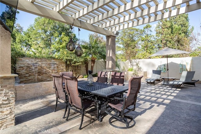 view of patio with outdoor dining space, a fenced backyard, and a pergola