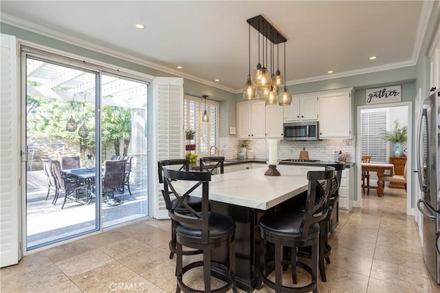 dining space featuring recessed lighting and crown molding