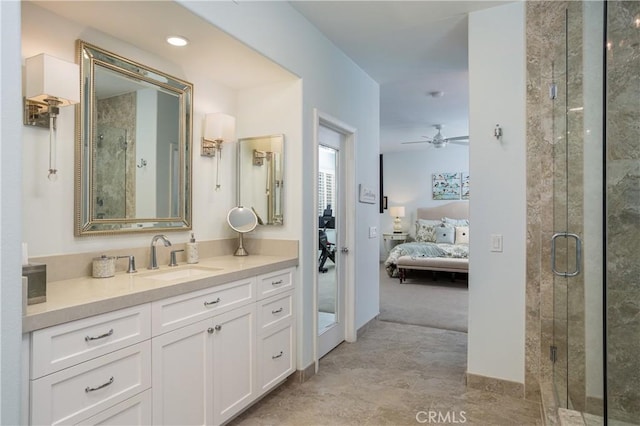 bathroom featuring connected bathroom, baseboards, ceiling fan, a stall shower, and vanity