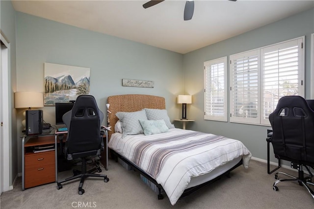 bedroom with baseboards, light colored carpet, and a ceiling fan