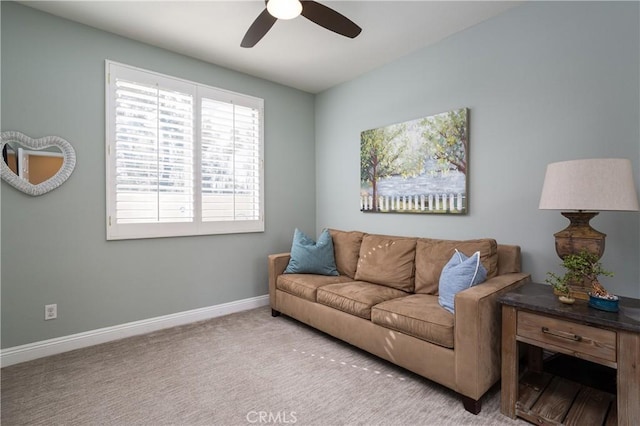 living area featuring a ceiling fan, baseboards, and carpet floors