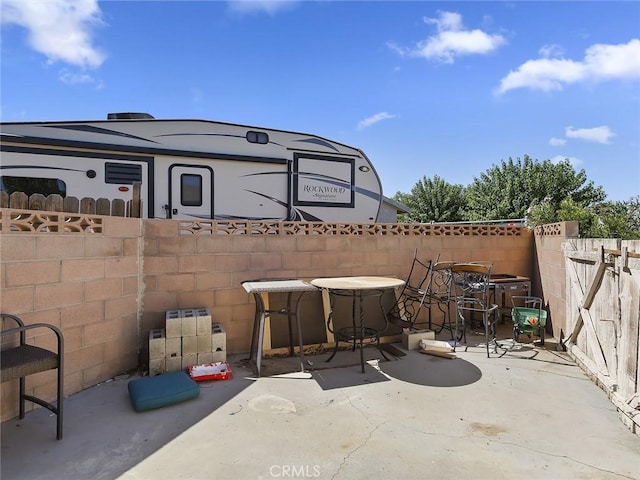 view of patio featuring fence