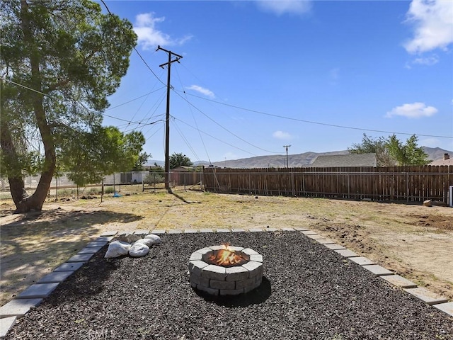 view of yard featuring a fire pit and fence