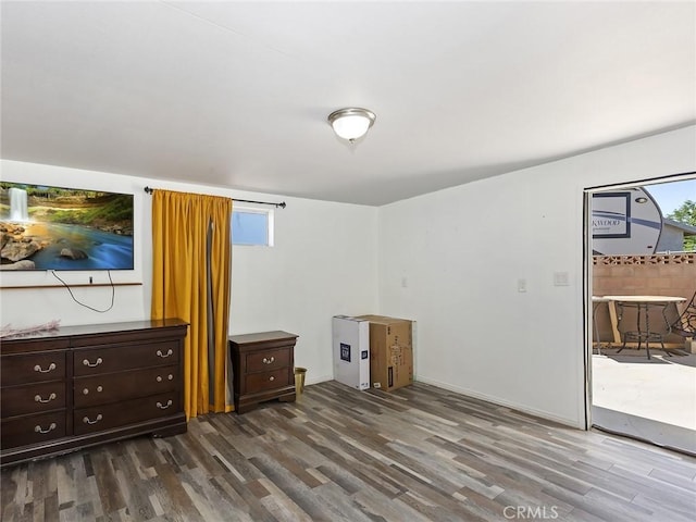 interior space with access to outside, multiple windows, and wood finished floors