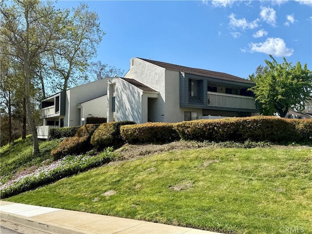 view of front of home featuring a front lawn and stucco siding