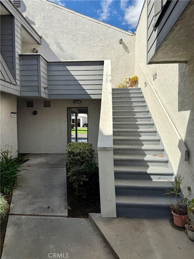 entrance to property with stucco siding