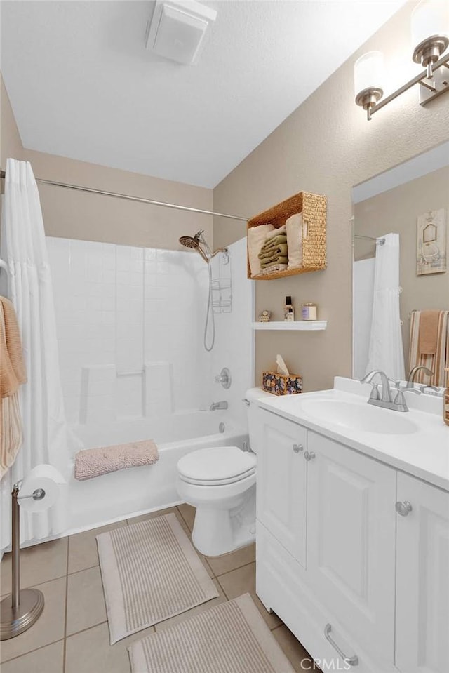 bathroom with tile patterned flooring, toilet, vanity, and shower / bath combo