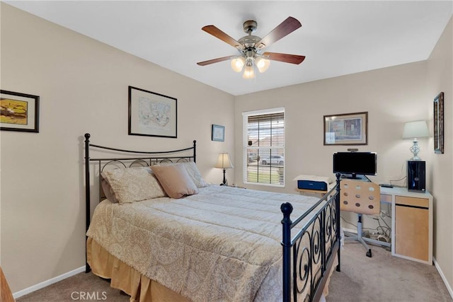 carpeted bedroom with baseboards and ceiling fan