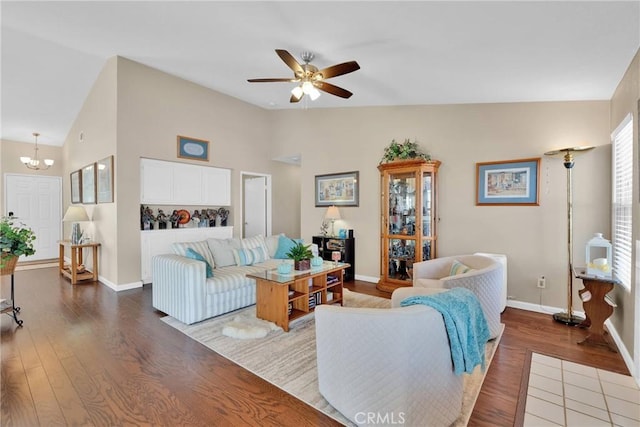 living area with ceiling fan with notable chandelier, baseboards, and wood finished floors