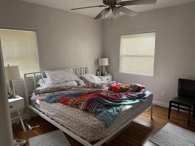 bedroom with baseboards, wood finished floors, and a ceiling fan