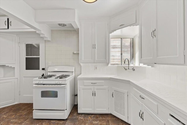 kitchen with white cabinetry, light countertops, white range with gas stovetop, and tasteful backsplash