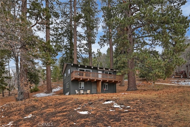 back of property featuring a wooden deck