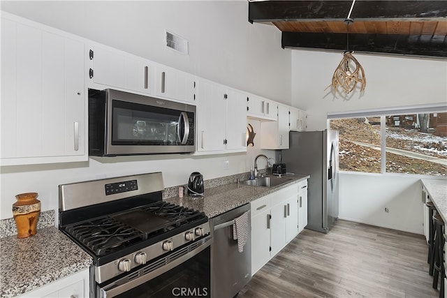 kitchen featuring visible vents, a sink, wood ceiling, appliances with stainless steel finishes, and beamed ceiling