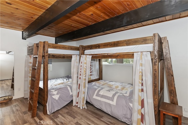 bedroom featuring wooden ceiling, beamed ceiling, and wood finished floors