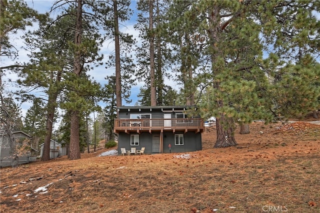 back of house featuring a wooden deck