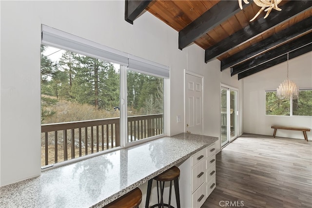 interior space featuring lofted ceiling with beams, a notable chandelier, and wooden ceiling