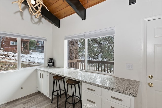 kitchen featuring white cabinetry, plenty of natural light, and light wood finished floors