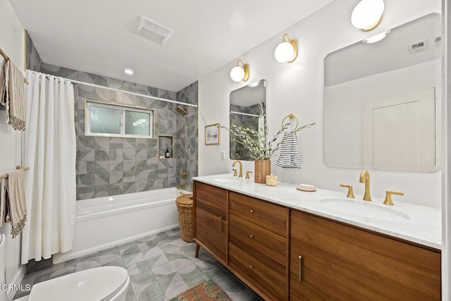 full bath featuring a sink, visible vents, shower / bath combo with shower curtain, and toilet