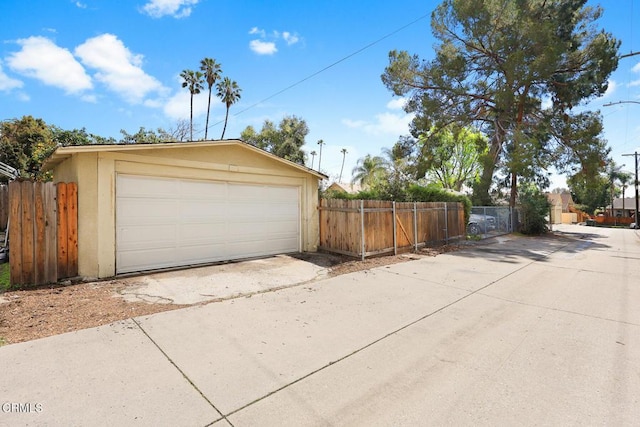 detached garage featuring fence