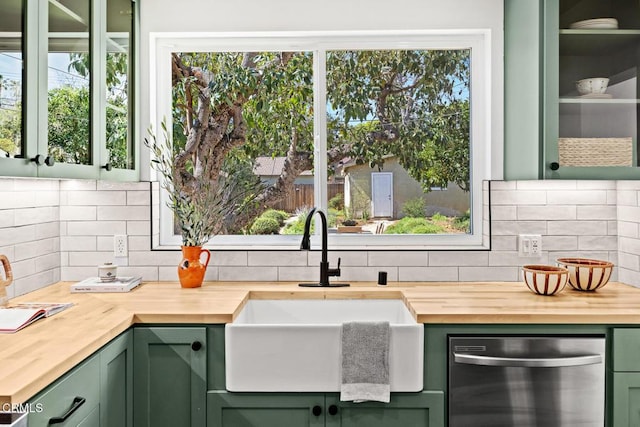 kitchen featuring green cabinets, a sink, and butcher block counters