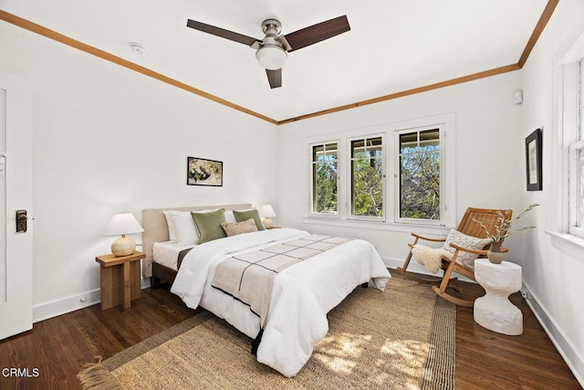 bedroom featuring baseboards, wood finished floors, and ornamental molding