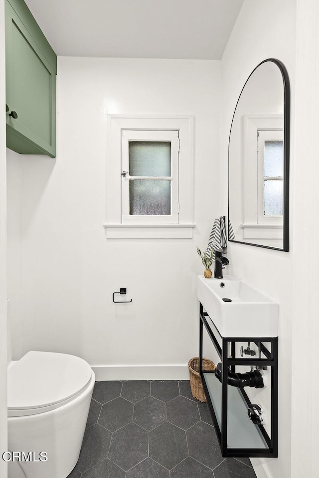 bathroom featuring vanity, tile patterned floors, toilet, and baseboards