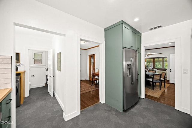 kitchen featuring visible vents, recessed lighting, a notable chandelier, stainless steel fridge, and green cabinetry