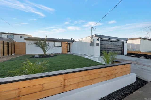 mid-century home featuring a garage, fence, a front yard, and stucco siding