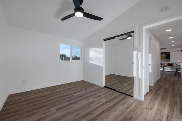 spare room featuring recessed lighting, lofted ceiling, and wood finished floors