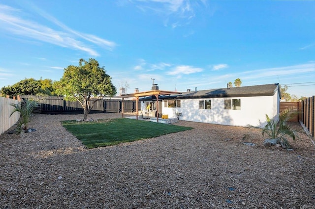 back of property with a yard, stucco siding, a patio, and a fenced backyard