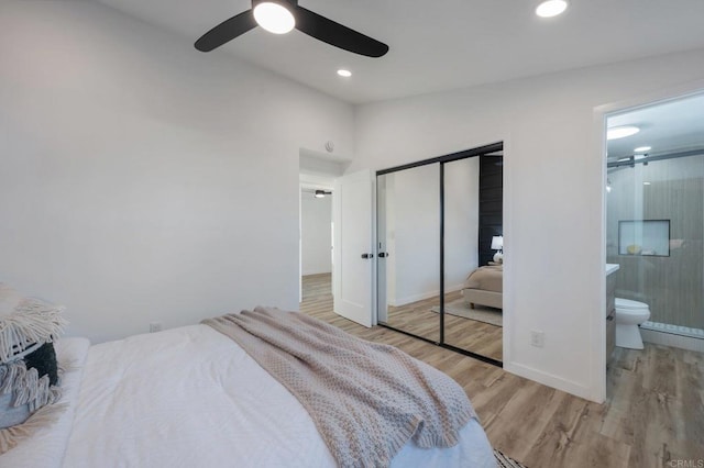 bedroom with wood finished floors, ensuite bath, recessed lighting, ceiling fan, and a closet