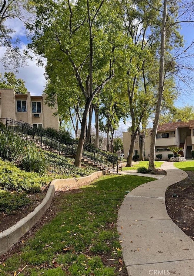 view of home's community featuring a lawn and fence