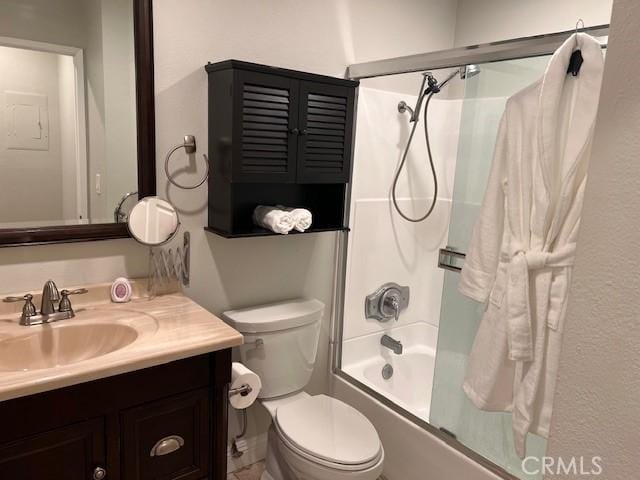 bathroom with vanity, toilet, and combined bath / shower with glass door