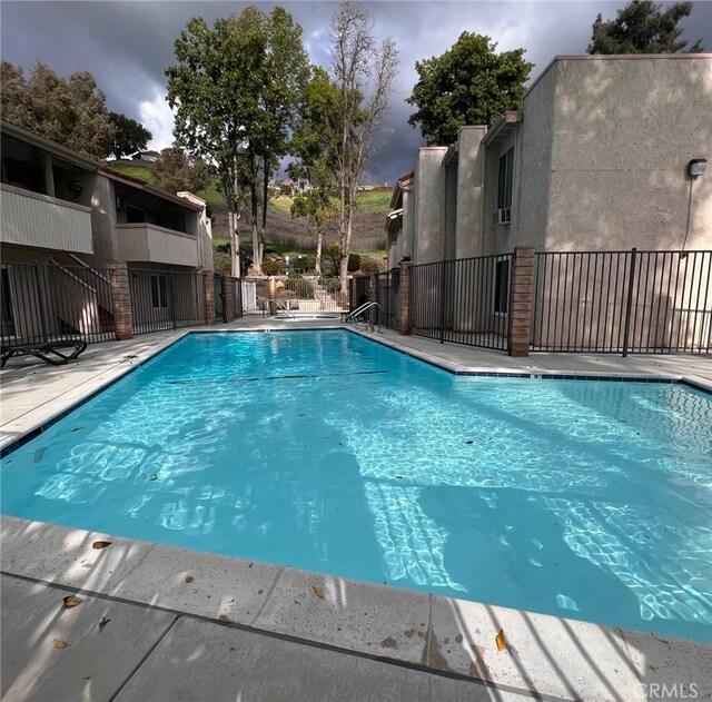 community pool featuring fence