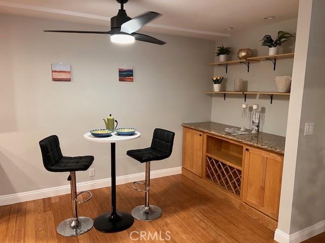 28947 Thousand Oaks Blvd Unit 134, Agoura Hills, CA 91301 - dining space featuring wood finished floors, a ceiling fan, and a bar