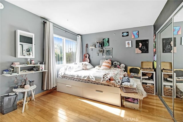 bedroom with a closet and wood finished floors