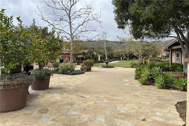 surrounding community featuring a patio and a mountain view