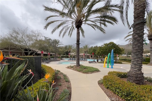 view of property's community featuring playground community and a pool