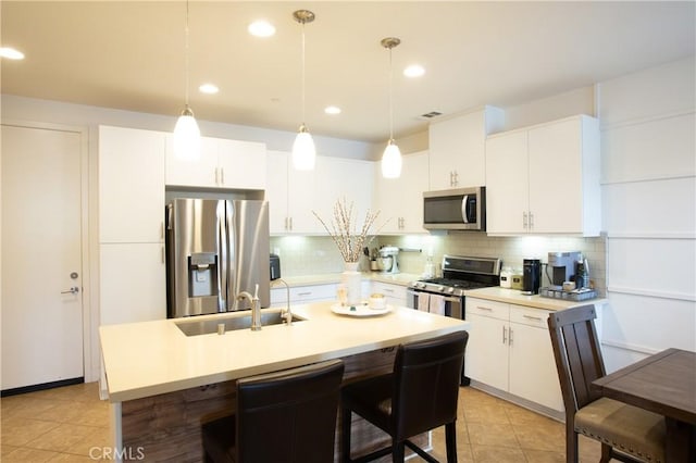 kitchen featuring a sink, stainless steel appliances, backsplash, and visible vents