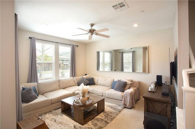 living area featuring a ceiling fan, carpet, and visible vents