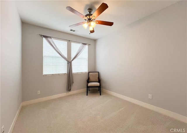 unfurnished room featuring visible vents, light colored carpet, baseboards, and ceiling fan