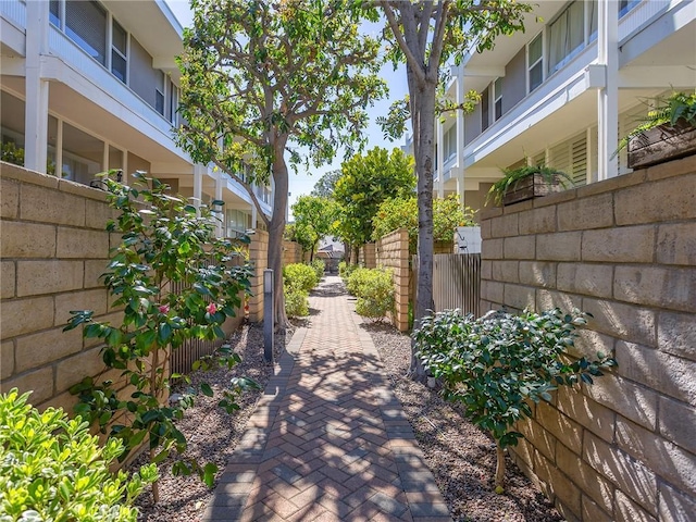 view of home's community featuring fence