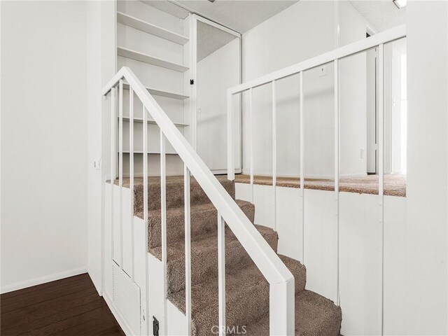 stairway with wood finished floors