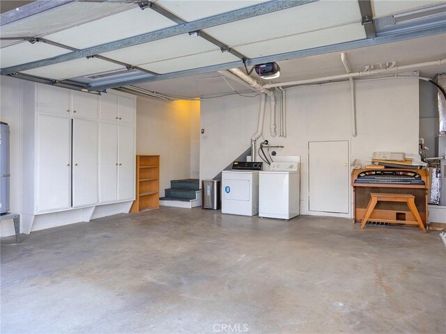 garage with a garage door opener and washer and clothes dryer