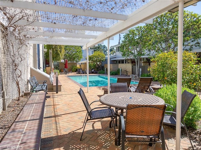 view of pool featuring outdoor dining area, a pergola, a patio, fence, and a fenced in pool