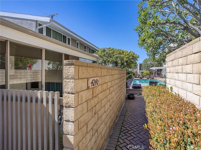 view of side of property featuring fence and a fenced in pool