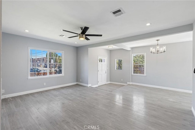 interior space with wood finished floors, visible vents, and baseboards